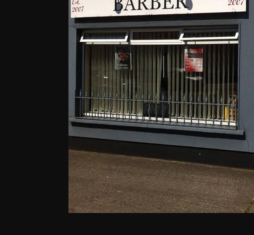 The BARBER sign and window at O'Neill's Clip Joint, Ballivor, with Walk-ins Welcome in the glass